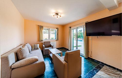 a living room with a couch and a flat screen tv at Beautiful Home In Vela Luka in Vela Luka