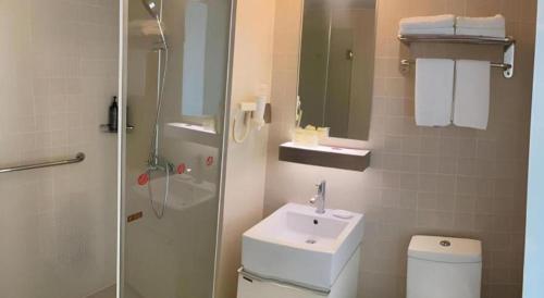 a bathroom with a toilet and a sink and a shower at Jinjiang Inn Select Shanghai Fengxian Baolong Square North Yunhe Road in Shanghai