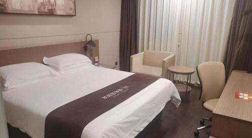 a hotel room with a bed and a chair at Jinjiang Inn Select Shanghai Fengxian Baolong Square North Yunhe Road in Shanghai