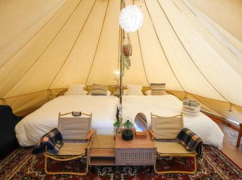 a bedroom with a bed in a tent at リバーサイドグランピングNuts in Higashiomi