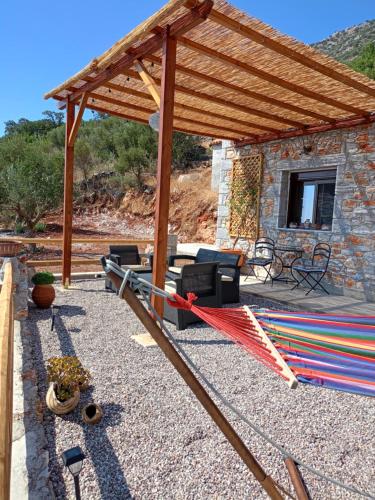 a patio with a hammock under a wooden pergola at Sofilia view house in Argilia