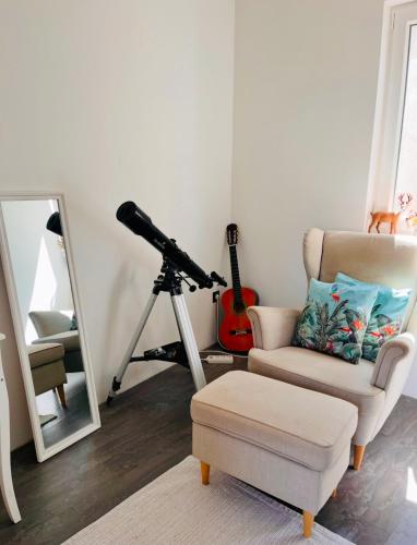 a room with a camera and a chair and a mirror at Sea View Beachfront Apartment Maslina in Omiš