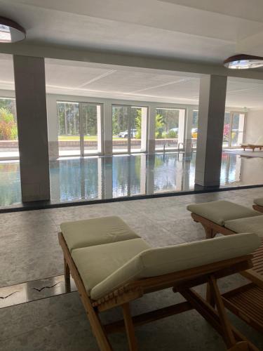 a room with two beds and a swimming pool at Maison Poluc Boutique Hotel in Champoluc