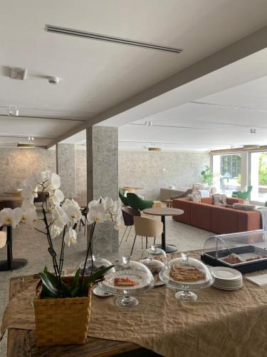 a living room with a table with plates of food at Maison Poluc Boutique Hotel in Champoluc
