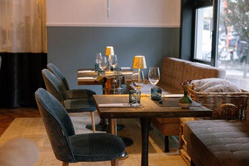 a dining room with wine glasses on tables at Hotel Cocoon in Ostend