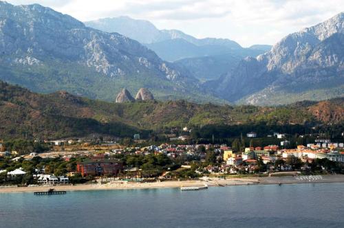 a town on a beach with mountains in the background at Camyuva Beach Hotel in Kemer