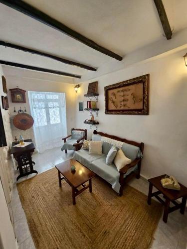 a living room with a couch and a table at Aelia in Ioulis