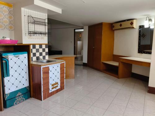 a kitchen with a sink and a counter top at Naza Orchid Pattaya in Pattaya South