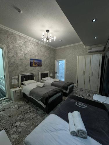 a bedroom with three beds in a room at Next Hotel Samarkand in Samarkand