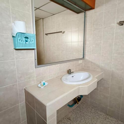 a bathroom with a sink and a mirror at Naza Orchid Pattaya in Pattaya South