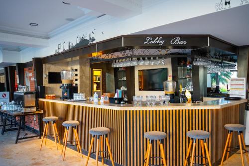 a bar with bar stools in a restaurant at Camyuva Beach Hotel in Kemer