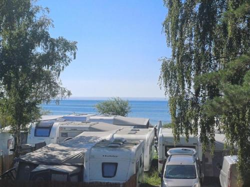 a group of rvs parked next to the ocean at Maszoperia Sun4hel Kite & Wind & Surf in Jastarnia