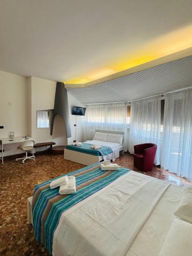 a hotel room with two beds and a desk at MMM HOME Train Station 3 in Mestre