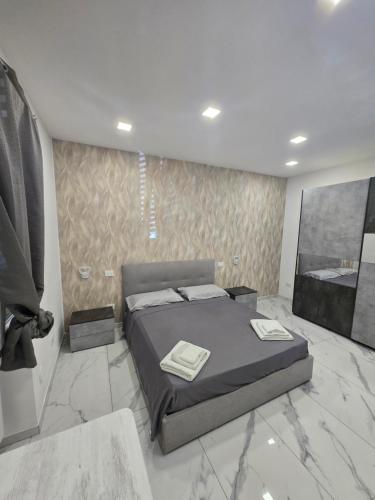 a bedroom with a bed with two towels on it at Sweet home in Brindisi