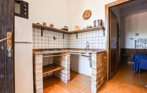 a small kitchen with a sink and a stove at Amazing Apartment In Trappeto With Wifi in Trappeto