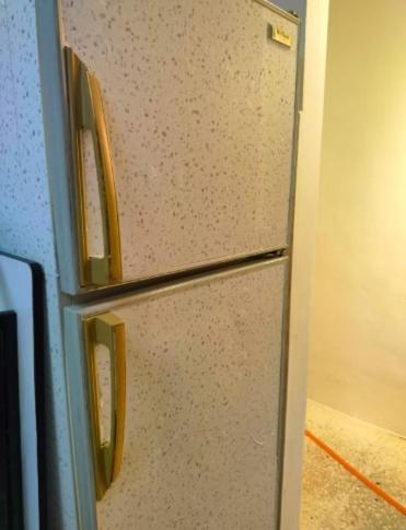 a refrigerator with two handles in a kitchen at Comfy Room Near to Penang Bridge in George Town