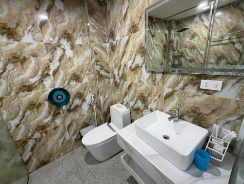 a bathroom with a sink and a toilet and a mirror at Dream Hotel in Hanoi