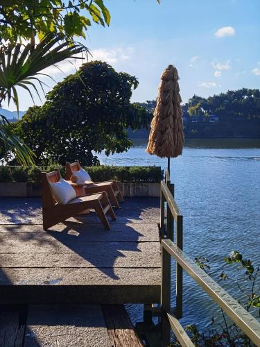 a person sitting in a chair next to a body of water at Yang Liping Xianguo'an Moon Palace Villa, Shuanglang, Dali in Dali Shuanglang