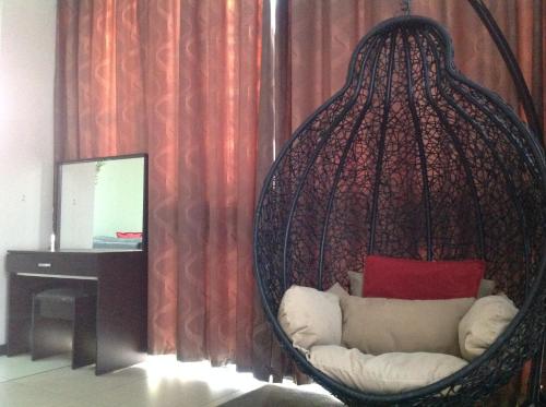 a hanging chair with a couch in a room at Alcazaba Hotel in Johannesburg