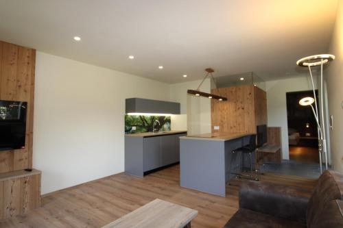 a living room with a counter and a kitchen at Bognerhof in Rifiano