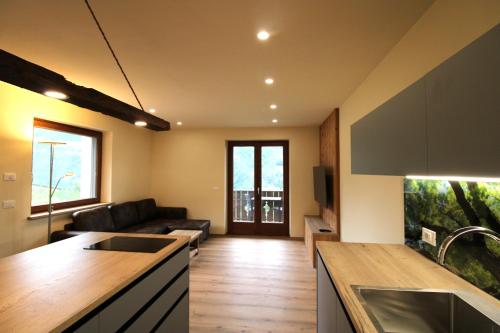 a kitchen and living room with a couch at Bognerhof in Rifiano