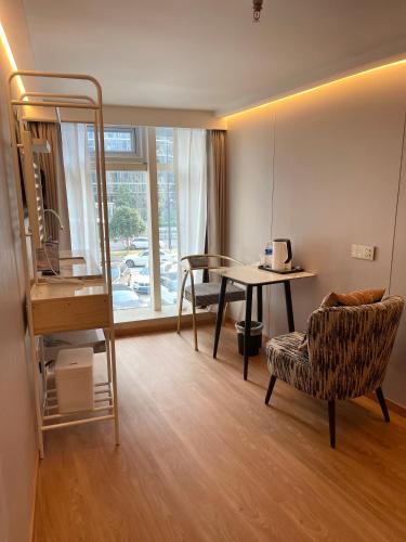 a room with a bunk bed and a table and a chair at 上海璞逸酒店-豫园 新天地 老西门地铁站店 in Shanghai