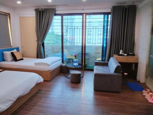 a hotel room with two beds and a window at Dream Hotel in Hanoi