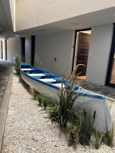 a blue canoe sitting on the side of a house at Ponton Apartman Alsóőrs in Alsóörs