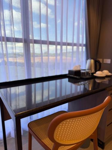 a desk with a chair in front of a window at GrandWara Khao Yai แกรนด์วารา เขาใหญ่ in Ban Nong Song Hong