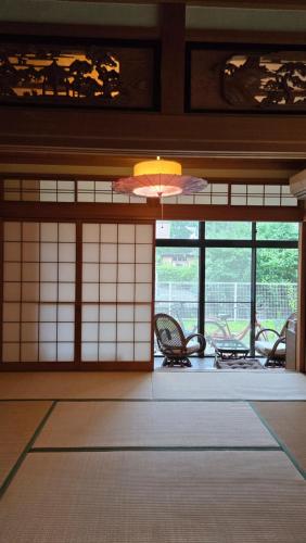 a room with chairs and windows in a building at 海の風 in Wakayama