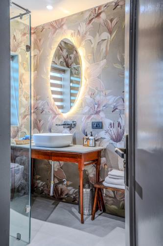 a bathroom with a sink and a mirror at Girisadan Boutique Stay in Jaipur