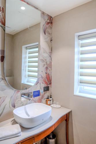 a bathroom with a white sink and a mirror at Girisadan Boutique Stay in Jaipur
