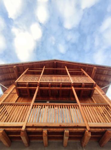 a wooden bench on top of a building at BATAJA - Dolomites Lodge in Valle di Cadore