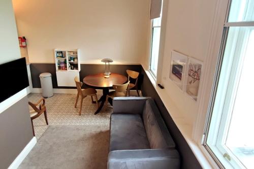 a living room with a couch and a table at Comfortable flat in a very historic part of London in London