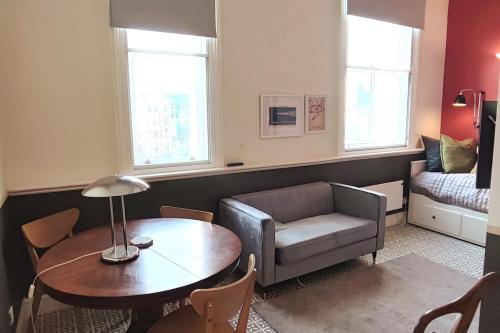 a living room with a couch and a table at Comfortable flat in a very historic part of London in London