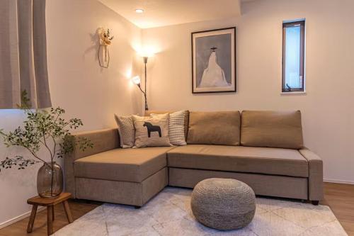 a living room with a brown couch and a table at Skytree View! Modern Entire House in Tokyo in Tokyo