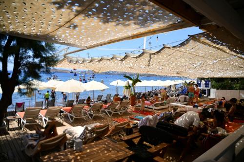 a group of people sitting in chairs on a beach at MyElla Boutique Hotel in Mugla