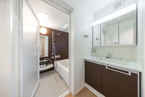a bathroom with a sink and a tub and a toilet at Skytree View! Modern Entire House in Tokyo in Tokyo