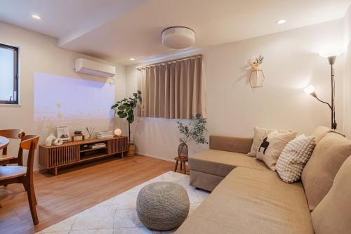 a living room with a couch and a table at Skytree View! Modern Entire House in Tokyo in Tokyo