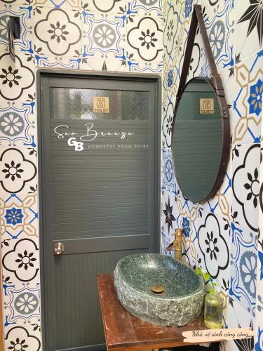 a bathroom with a sink and a mirror at Sea-Breeze Homestay in Phan Thiet