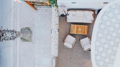 an aerial view of a bathroom with two white chairs at Lambi beach City Suite in Kos