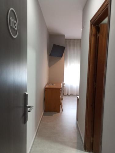 a hallway with a door and a desk in a room at Hotel Santa Fe in Santa Fe