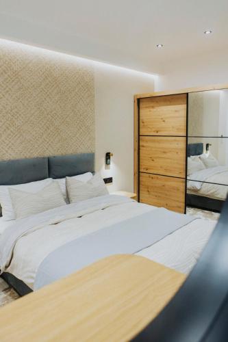 a bedroom with a large bed and a mirror at Lambi beach City Suite in Kos