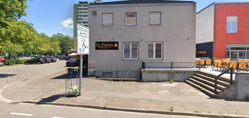 a building with a sign on the side of it at Le Patron Hotel in Lahr