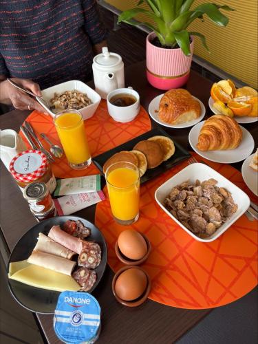 a table with breakfast foods and drinks on it at Le Saint-Pierre in Mézidon-Canon
