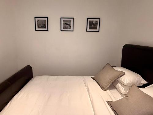 a bedroom with a bed with three pictures on the wall at NO4 Lilliput - Sandton Executive Guest House - OPENING SPECIAL in Sandton