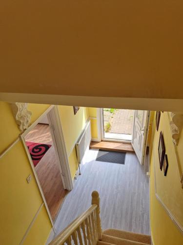 an overhead view of a hallway with a door and stairs at London Ilford town house - close to train station in Ilford