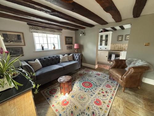a living room with a couch and a table at Crabapple Cottage adult only in Castle Donington