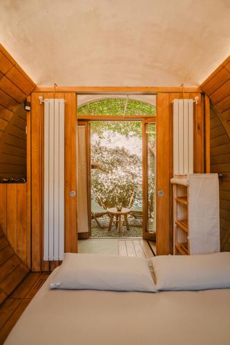 a bedroom with a bed and a view of a patio at el Riad de l'Empordà in Capmany