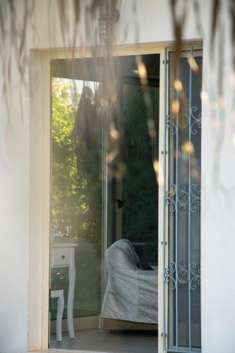 an open glass door with a couch in a room at Evoikos beach & resort in Livanátai